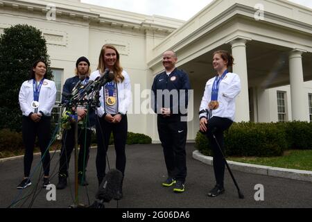 Reportage:   Athletes from the 2014 Olympic and Paralympic Winter Games speak to the media outside the White House, before an East Room event honoring them hosted by President Barack Obama and first lady Michelle Obama, Washington, D.C, April 3, 2014. From left to right: Julie Chu of Fairfield, Conn, who won silver with the women's ice hockey team; Sage Kostenberg of Park City, Utah, who won a gold medal in slopestyle snowboarding; Mikaela Shiffrin, from Eagle-Vail, Colo., who won gold in Womenâ€™s Slalom; Jon Lujan of Littleton, Colo., Paralympics Alpine Skiing, former US Marine Corps sergean Stock Photo