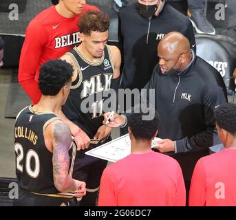 Atlanta Hawks players John Collins and Trae Young look on as interim head coach Nate McMillan helps lead his team to a 113-96 victory over the New York Knicks on Sunday, May 30, 2021, in Atlanta, Georgia. (Photo by Curtis Compton/The Atlanta Journal-Constitution/TNS/Sipa USA) Credit: Sipa USA/Alamy Live News Stock Photo