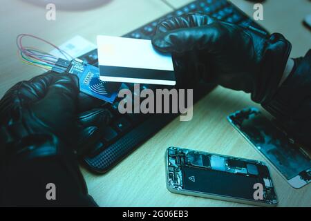 Hacking concept. Hacker trying to steal mobile payment information Stock Photo