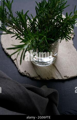 Jar of fresh rosemary on black slate background, Italy, Europe Stock Photo