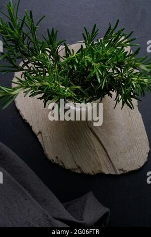Jar of fresh rosemary on black slate background, Italy, Europe Stock Photo