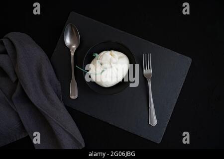 Burrata, fresh cheese, originally from Apulia made from cow's milk, with a spun paste and roundish shape with an external appearance similar to mozzar Stock Photo