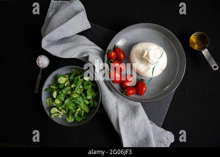 Burrata, fresh cheese, originally from Apulia made from cow's milk, with a spun paste and roundish shape with an external appearance similar to mozzar Stock Photo