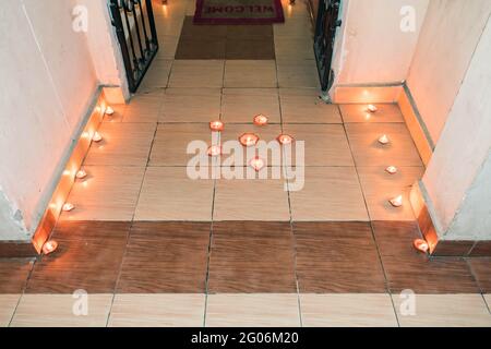 oil lamp or Diwali Diya also known as diva made of clay glowing decoration in diwali festival in front of flat. Diwali is biggest festival of India. Stock Photo