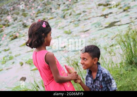The beautiful two baby in the lotus pond Stock Photo