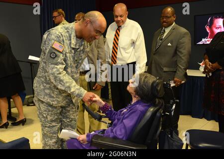 Reportage:   Brig. Gen. Norvell V. Coots, deputy commanding general for support and the assistant surgeon general for force projection, greets World War II Army veteran 106-year-old Alyce Dixon after she was honored at a women's history month event at the Pentagon, March 31, 2014. Dixon, who was a member of the Women's Army Corps, served in Europe during World War II as a member of the 6888th Central Postal Directory Battalion. The 6888th was the only unit of African-American women in the WAC to serve overseas in England and France during World War II.