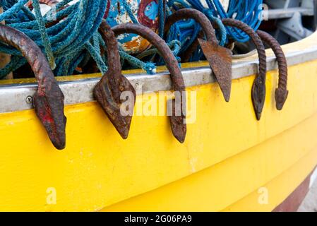 close-up of fishing equipment in a boatincluding anchors, rope and nets Stock Photo