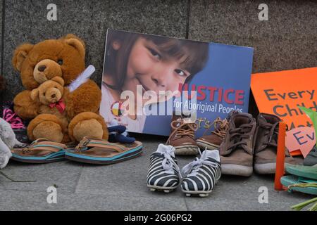 Ottawa, Canada. June 1st, 2021. A memorial to the 215 children found buried at a former Kamloops, British Columbia residential school laid at the Centennial Flame in front of the Canadian Parliament. People have been bringing kids shoes, stuffed animals and flowers to pay respect to the children whose bodies were uncovered in the grounds of the former Kamloops Indian Residential School as Canadians continue to wrestle with the history of Aboriginal Residential Schools throughout the country, as well as the historical treatment of First Nations communities. Credit: meanderingemu/Alamy Live News Stock Photo