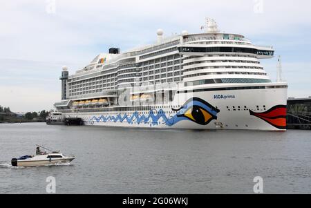 01 June 2021, Mecklenburg-Western Pomerania, Warnemünde: The 'Aidaprima' has moored at the cruise terminal without passengers. The ship is to be prepared for its first voyage after the Corona crisis in Warnemünde in the coming weeks. The 'Aidaprima' will set off from Kiel on seven-day cruises from 10.07.2021. The new cruise start in Warnemünde is planned by the shipping company Aida Cruises for 01.07.2021 with the 'Aidasol'. Photo: Bernd Wüstneck/dpa-Zentralbild/dpa Stock Photo
