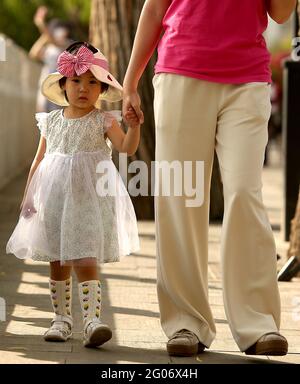 Beijing, China. 01st June, 2021. A mom walks with her daughter along a lake in Beijing on Tuesday, June 1, 2021. China says it will allow couples to have three children, up from two, as the Communist Party attempts to reverse declining birthrates and aver a population crisis, but experts say it is woefully inadequate. Photo by Stephen Shaver/UPI Credit: UPI/Alamy Live News Stock Photo