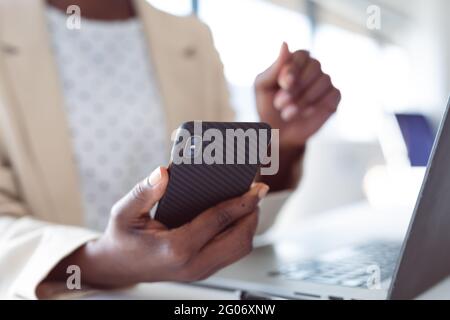 Close up of hands of african american businesswoman using smartphone Stock Photo