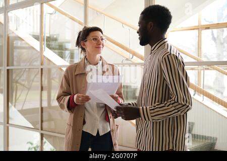 Two business partners discussing business contract in team while working at office Stock Photo