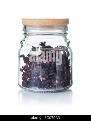 Dry hibiscus flowers in a glass jar isolated on a white background. Stock Photo