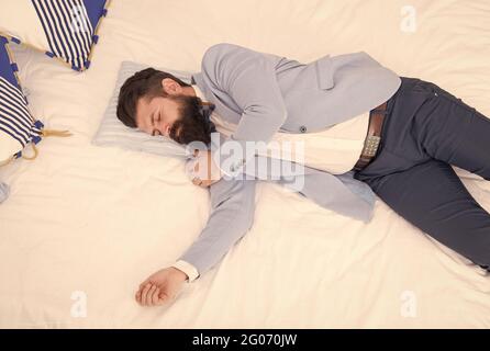 Sleeping in fashionable clothes. Recovery and recharging. Feel tired and sleepy. Sleepy guy in formal clothes sleep bed top view. Lack of sleep. Need Stock Photo