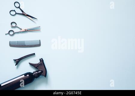 Set of professional hairdresser tools with combs and styling on blue background top view mock up Stock Photo