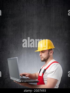 Construction worker with his laptop Stock Photo