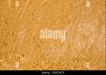 Wave on the sand beach background. sand and water texture. Sand beach and wave. Beach sand sea water summer background. beach desert texture. top view Stock Photo