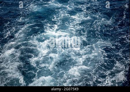 sea water wake, dark blue sea and white foam. sea water wake, dark blue and white foam. Blue sea water texture Stock Photo