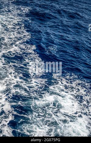 Water splashed use for graphic design. texture dark blue sea and white foam top view. Blue sea texture with waves and foam Stock Photo