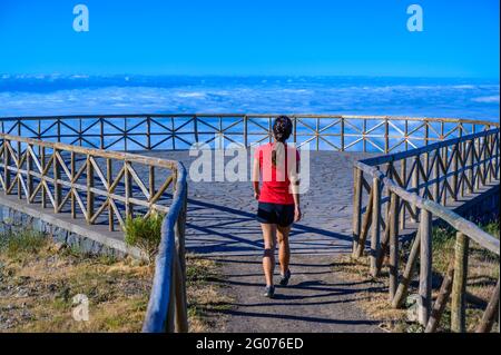 Hiker in Madeira Island - View Point of mountain scenery of the highland - tabove the clouds - ravel destination for outdoor sports - Portugal Stock Photo
