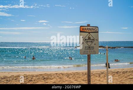 Strong currents warning sign at tropical beach Hawaii rip tides Stock Photo