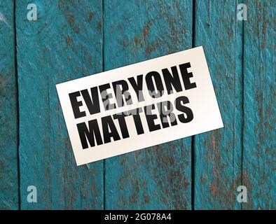 Everyone Matters written on a card. on a wooden table. Equality social concept Stock Photo