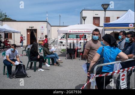 People wait from the anamnesis point to receive their vaccine shots during the mass vaccination.Mass vaccination started in Vulcano island under the guidance of Sicilia Region team, the Special Commissioner for Covid-19 Emergency for Messina Metropolitan Area (Ufficio Commissario Ad Acta per l’Emergenza Covid-19 per l’Area Metropolitana di Messina) and the Red Cross local team. Doses of Moderna and Johnson & Johnson vaccines were administered to residents in order to implement the “Covid-free islands” program for the summer. Stock Photo