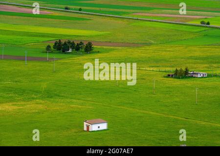 top view of farms amidst green meadows in the mountains. Abruzzo, Italy, EUropa