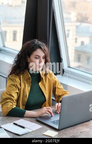 Young businesswoman using laptop at her work while working at her workplace at office Stock Photo
