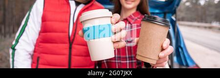 cropped view of man and woman holding reusable and paper cups, banner Stock Photo