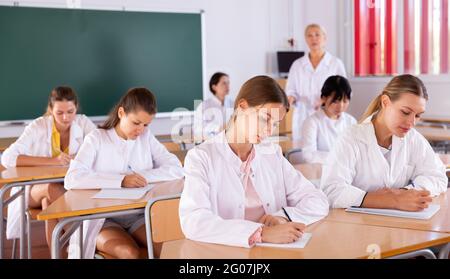 Medical students writing in notepads Stock Photo