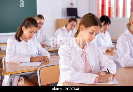 Medical students writing in notepads Stock Photo