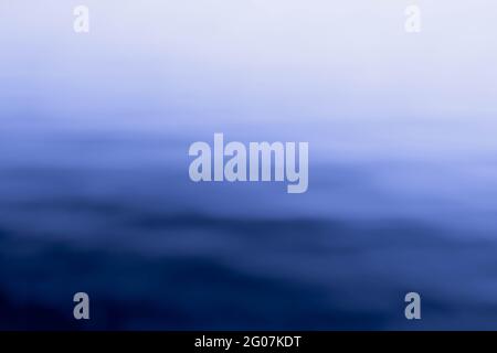Abstract shot of blurred sea water surface with skyline. Background, pattern, texture Stock Photo