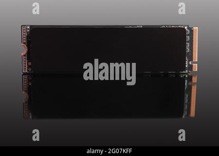 SSD M2 disk close up; on dark background with reflection. Isolated on gray; clipping path included Stock Photo