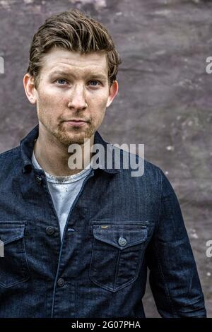 handsome man covered by mud.A man's face covered in muddy spots Stock Photo
