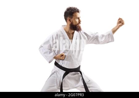 Bearded man in kimono practicing martial arts isolated on white background Stock Photo