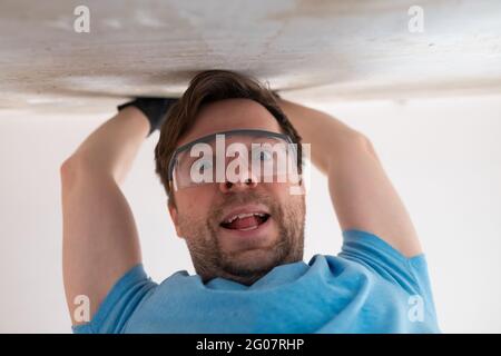 Caucasian man in special glasses for repairment. Stock Photo