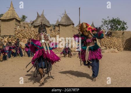 Mask dancers in the village of Tireli, Dogon country, Mali Stock Photo