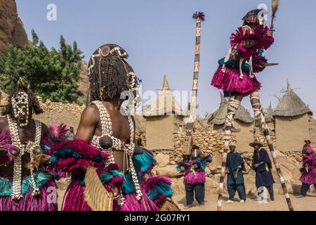 Mask dancers in the village of Tireli, Dogon country, Mali Stock Photo