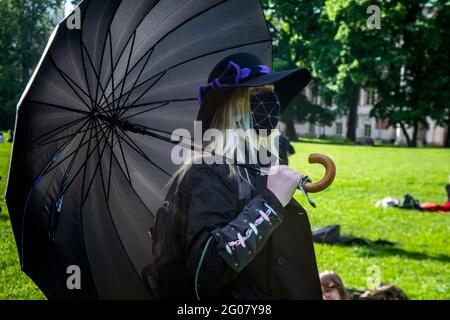 Moscow, Russia. 1st of June, 2021 Traditional meeting of fans of the hippie subculture in the Tsaritsyno Park of Moscow, Russia. Several dozen of people from different subcultures take parts of the open air to enjoy alternative arts and music. The girl wear face mask during the novel coronavirus COVID-19 pandemic in Russia Stock Photo