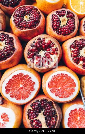 Top view of ripe grapefruits and pomegranates without peel on top arranged on stall on street market in Turkey Stock Photo