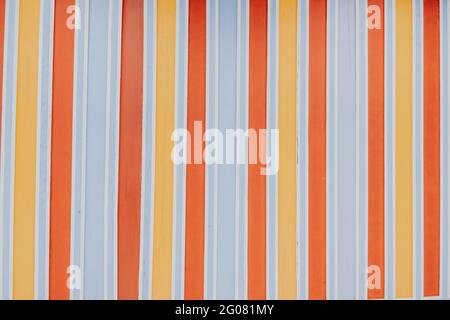 Background of stripped painted wall in orange, white, blue and yellow Stock Photo
