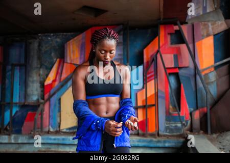 Sporty Woman taking off jacket Stock Photo