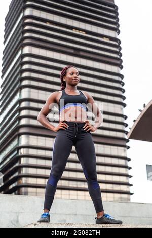 Muscular Woman posing in city Stock Photo
