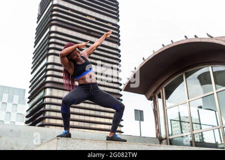 Muscular Woman posing in city Stock Photo