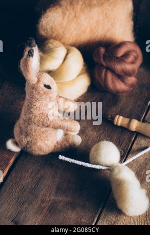 Hand made easter rabbit made of wool and felt on dark wooden table Stock Photo
