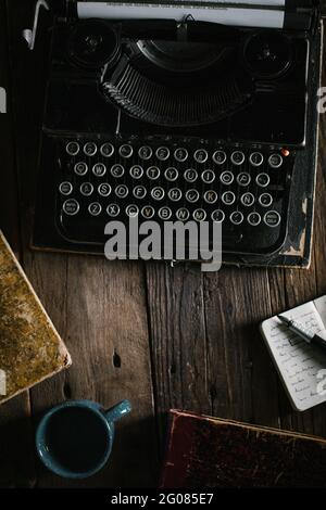 Retro vintage typewriter standing on old wooden table Stock Photo