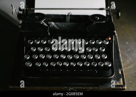Retro vintage typewriter standing on old wooden table Stock Photo