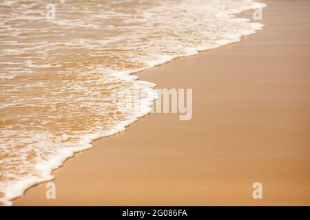 Texture background of sandy beach with gentle soft waves Stock Photo