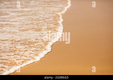 Abstract background of soft waves on smooth sandy beach Stock Photo